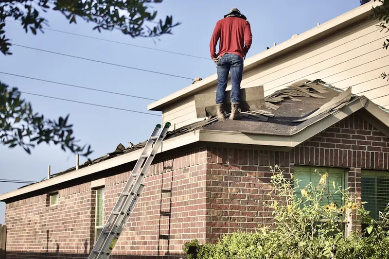 Professional roofer working on a residential roof in Stoneman